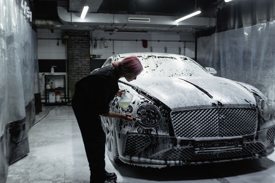 Foam brush washing a car during an exterior hand wash